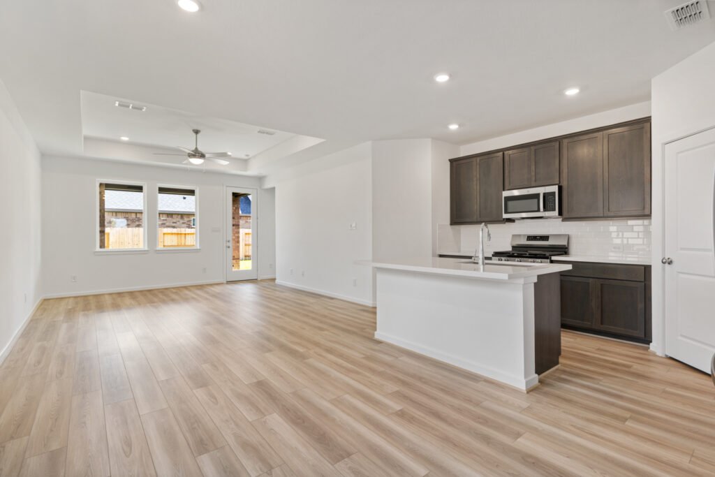 Open living room and kitchen with dark cabinets