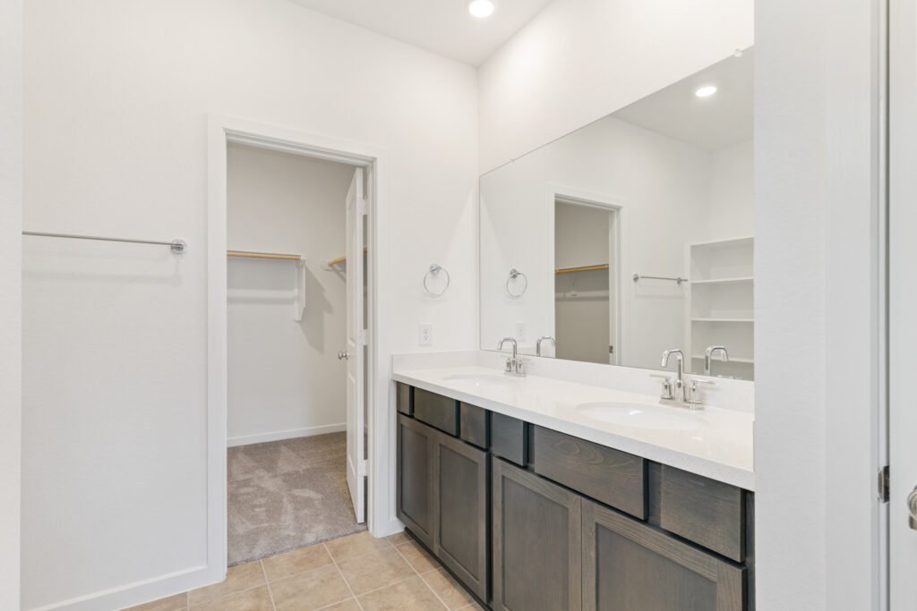 Bathroom with double vanity and walk-in closet