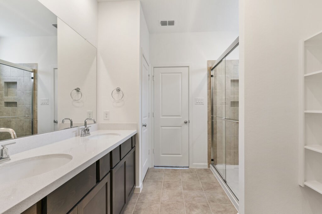 Bathroom with double vanity and glass shower