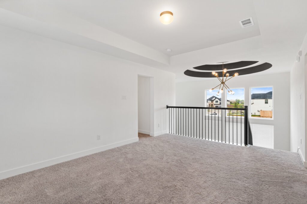 Upstairs loft with chandelier and railing